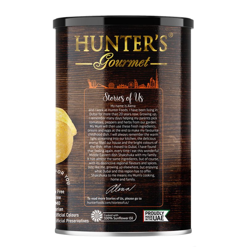 Hunter’s Gourmet Hand Cooked Potato Chips – Shakshuka – Middle Eastern Flavours (150gm) Shakshuka on its own is already an ambitious flavour combination, and we still boldly and perfectly flavoured our Hand Cooked Potato Chips with it! The aroma of tomatoes and garlic combined with the subtle heat of the spices, the richness in the flavour balanced with herbs and the golden yolks taste of the poached eggs perfectly pull everything together to tickle your taste buds. Do You Know? Shakshuka, meaning “all mixed up”, is usually a vegetarian dish that uses tomatoes, onions, spices as the base with embedded poached eggs. Middle Eastern cuisine is full of flavours and an array of adventurous spices. We are truly inspired by the land we make our chips on, by our love of the food and people around us, we created this range of Hunter’s Gourmet Hand Cooked Potato Chips replicating some of the most famous and beloved Middle Eastern dishes: Shawarma, Fattoush, Shakshuka. While you are enjoying and savouring these bold and vibrantly flavoured chips, you could also read about Stories of Us, all the people who work at Hunter Foods, who make the chips happen, and their stories and life in the Middle East. Hunter’s Gourmet Hand Cooked Potato Chips – Shakshuka – Middle Eastern Flavours (150gm) 150gm Canister. Potato Chips, Vegan, Vegetarian, Gluten Free, MSG Free, Non GMO, No Artificial Preservatives, No Artificial Colours, No Trans Fat, No Cholesterol, Dairy Free, Lactose Free, Halal.